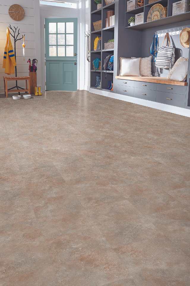 stone look luxury vinyl tile in modern home entryway with wooden bench and custom shelving